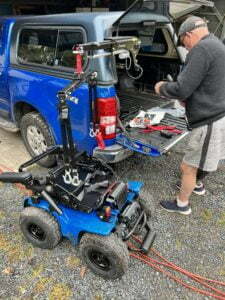 David using the hoist to lift the X8 into the back of his car.