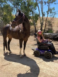 Leonie in her Extreme X8 walking her horse