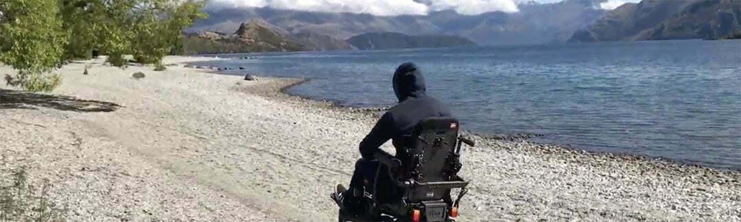 Nate on the beach on his Magic Mobility chair