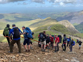 Rob climbs Mount Snowden without the use of his arms or legs thanks to his Magic Mobility chair and a great support team.