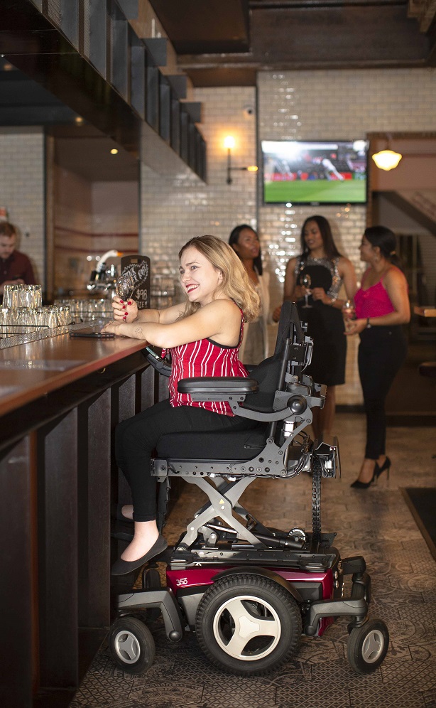 Maia ordering at the bar in her elevated Magic 360