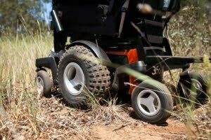 Close-up of the Magic 360 powerchair tackling outdoor terrain