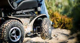 Close up of the Extreme X8 powerchair on the sand.